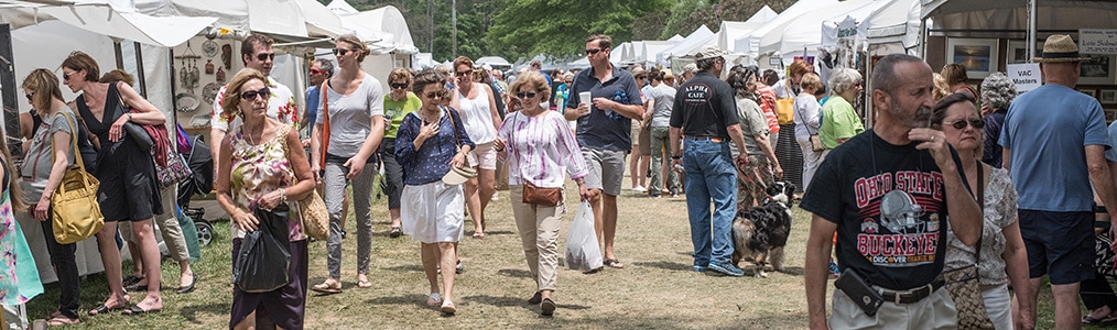 Crowds of festival patrons visiting artist tents